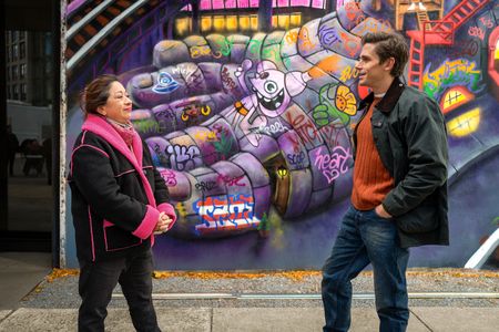 Artist Lady Pink meets with Antoni Porowski next to one of her murals. (National Geographic/Jill Worsley)