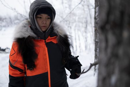 Evan Strassburg helping his father look for bear dens during the winter season. (National Geographic/Pat Henderson)