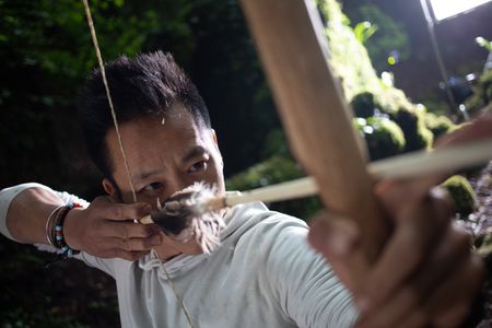 Coleford, UK - Albert Lin with bow and arrow. (National Geographic/Hugh Campbell)