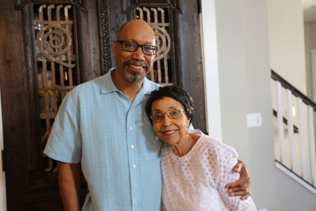 Stephen Woodson, son of Waverly Woodson Jr., poses for a portrait with his mother, Joann Woodson, at his home in Frederick, Md. Waverly Woodson Jr. was a combat medic who served with the 320th Barrage Balloon Battalion on D-Day. (National Geographic/Shianne Brown)