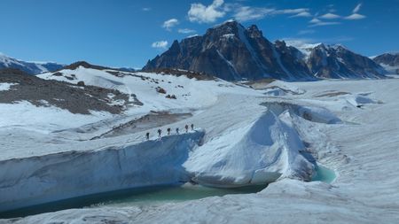 The full team hikes across the ice. (photo credit: National Geographic/Pablo Durana)