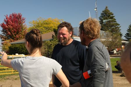 Beth Pol explains her ideal layout of the Pol family farm's new garden to Charles Pol and Ben Reinhold. (National Geographic)
