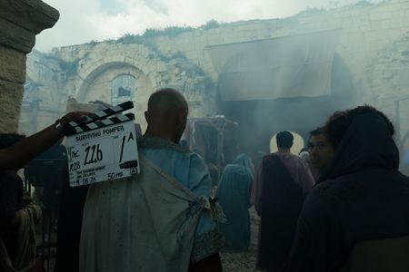 Behind-the-scenes as supporting artists prepare to flee through the gates of Pompeii following the initial eruption of Vesuvius. (National Geographic/Darrin Zammit Lupi)