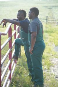 Dr. Hodges and his son, VJ, admire their cows at VSquared Farm as they wait for a special friend to arrive. (National Geographic for Disney/Nicholas Reaves)
