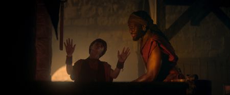 Avianius, played by Frankie Treadaway, playfully teases Marcus Masurius, played by Theo Ogundipe, as they stand around the forge hearth. (National Geographic)