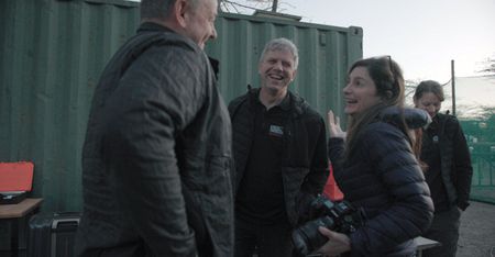 Ami Vitale, Thomas Hildebrant and Frank Goeritz from BioRescue, and Susanne Holtze (also from BioRescue)  in the background. In the early morning taking a break while prepping for a procedure. (credit: National Geographic)