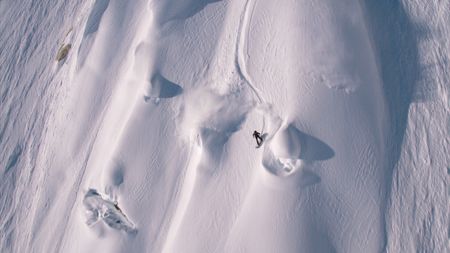 Travis Rice snowboards on a mountain in Alaska.  (photo credit: Travis Rice, Inc)