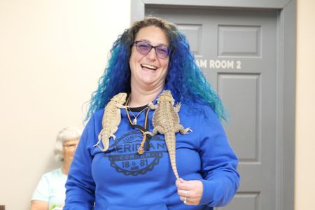 Owner April Sayler smiles with her two bearded dragons Otis and Grizilda during a routine check up. (National Geographic)