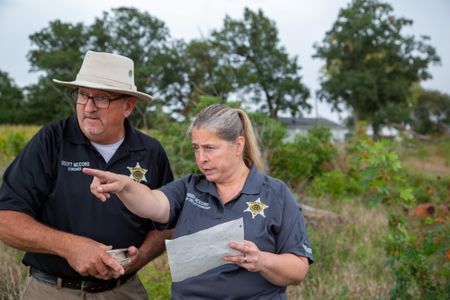 Coroner Scott McCord and Chief Deputy Heidi McCord return to the site where the body was discovered in 1983. (National Geographic/Tom Beard)
