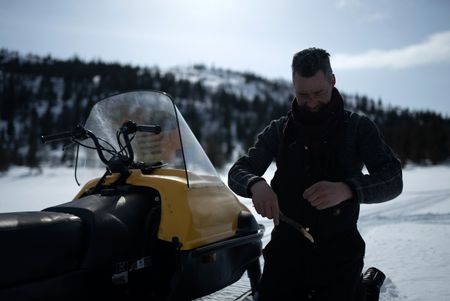 Joel Jacko sets a fishing line in the frozen lake. (National Geographic/Wayne Shockey)