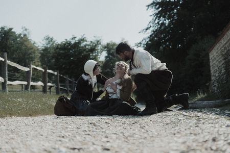 Mary Dunbar, afflicted by a scar on her shoulder, is looked over by two villagers. (Dash Productions Services LTD/Antoan Ivanov)