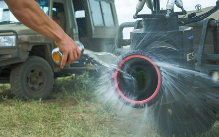 Water pouring onto a GSS camera with a rain spinner attachment to show how it works. (credit: National Geographic/Jigar Ganatra)