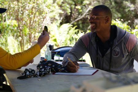 Christian Cooper writes down measurements as avian technician Bret Nainoa Mossman examines a forest bird at the Pu'u Maka'ala Natural Area Reserve. (National Geographic for Disney/Troy Christopher)
