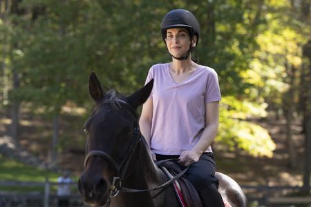 Debbie St. John rides a horse during her reunion with Stefan Horlacher. (National Geographic/Virginia Sherwood)