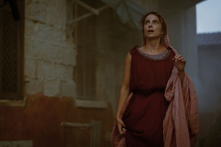 Claudia, played by Madeleine Walker, looks up at the eruption column of Vesuvius, her eyes wide in horror and fear. (National Geographic/Darrin Zammit Lupi)