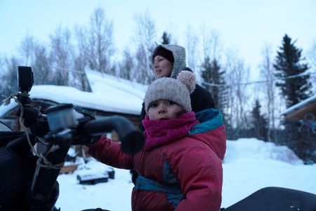 Chevelle Roach sits in a snowmobile, ready to set rabbit snares with her family. (BBC Studios Reality Productions, LLC/Jayce Kolinski)