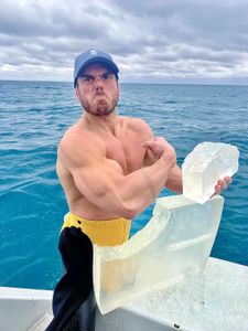 Ross Edgley holds a giant ‘Gello’ lollipop. If a tiger shark takes a bite, Ross and Mike Heithaus from Florida International University will be able to work out how much a tiger shark can eat. (National Geographic/Nathalie Miles)