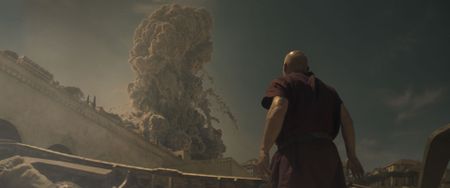 The Praetorian, played by Barry Aird, stands on the beach looking up in horror as the eruption column from Vesuvius towers into the sky over the city walls of Herculaneum. (National Geographic)