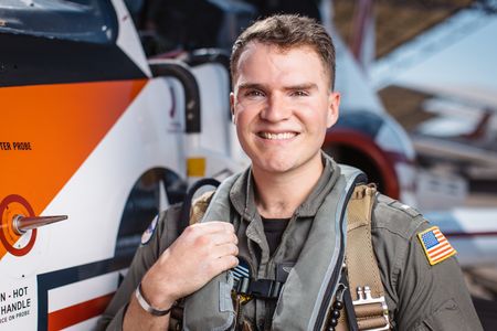Student LTJG Dylan Horan poses next to a T-45. (National Geographic/Freddie Claire)