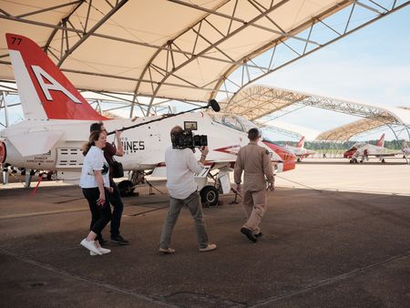 Director Lana Salah, DOP Jon Southgate-Sayers, student LTJG Andrew Seepe, and Sound Recordist Phil Bax out on the flight line. (Credit: National Geographic/Freddie Claire)