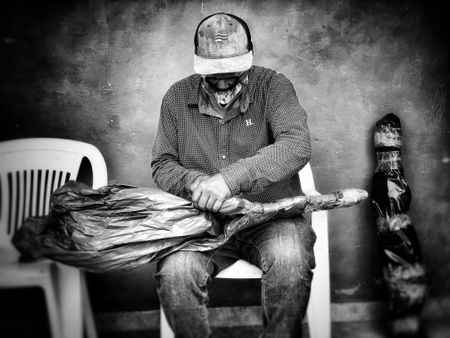 In Sinaloa, an old narco masked tapes bags of heroin together for shipment. (Nick Quested)
