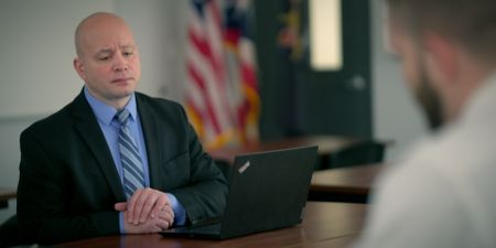 Sgt. Bryan Johnson of Stark County Sheriff's Office hears from DNA Doe Project volunteers. (National Geographic)