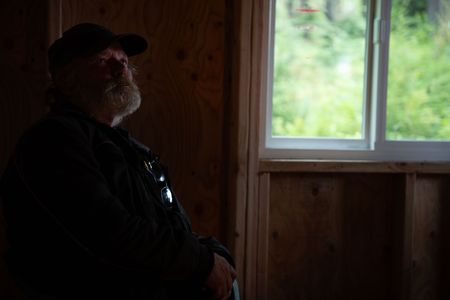 Terry Simpson is grateful for his neighbors' help in building him a new cabin. (National Geographic/Robert Jolley)