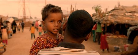 Kamal Hussein holding Dokana, a lost girl, in the Kutupalong Refugee Camp. Lost and Found, directed by Academy Award winner Orlando von Einsiedel (“The White Helmets”, “Virunga"), is an inspiring story of humanity and heroism in the world’s largest refugee camp, that follows Kamal Hussein, a Rohingya refugee who has dedicated his life to reuniting children with their parents. (Nobel Media/Franklin Dow)