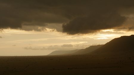 The escarpment rises along the edge of the prideìs territory, defining the landscape the lions call home. (National Geographic)