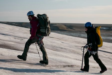 Andreas Alexander and Melissa Marquez hike up a glacier in Svalbard. (National Geographic/Mario Tadinac)