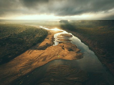 The iconic Chilojo Cliffs can be seen in the distance of the remote Gonarezhou National Park, Zimbabwe. (National Geographic for Disney/Freddie Claire)