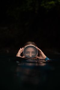 Dr Alex Schnell adjusts her dive mask on the surface while snorkeling in Lembeh Strait.  (National Geographic for Disney/Craig Parry)