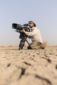 Cameraman Luke Nelson films African golden wolves on a dried up lake in Senegal. (National Geographic/Hedvika Michnova)