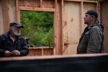 Terry Simpson is grateful for his friend David Squibb's help in building him a new cabin. (National Geographic/Robert Jolley)