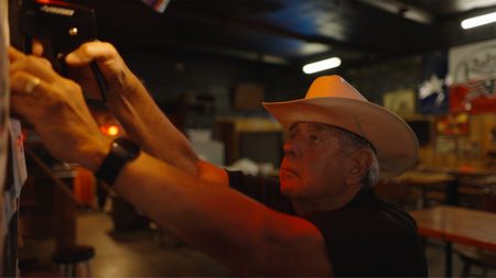 Detective David Turner of Smith County Sheriff's Office puts up missing posters with images of Jane Doe's facial reconstruction. (National Geographic/Will Francome)