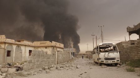QAYARRAH, IRAQ - After leaving Qayarrah, ISIS sets oil fires as a parting gift for the villagers. (photo credit:  Junger Quested Films LLC/Nick Quested)