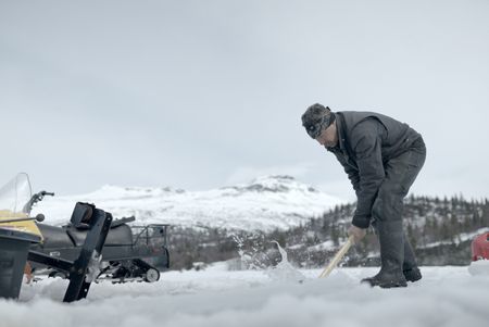 Joel Jacko cuts through the ice to use his saw mill. (National Geographic/Wayne Shockey)