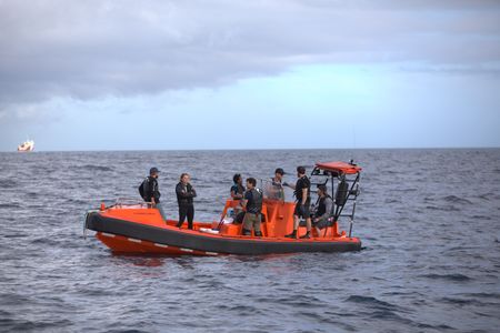 Matt Smukall, Erin Spencer, Zoleka Filander, Eric Stackpole, Aldo Kane and crew debrief after a great hammerhead tagging trip. (National Geographic/Paige McGarvin)