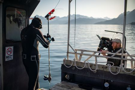 Shark Scientist Yannis Papastamatiou prepares to tag a salmon shark. (National Geographic for Disney/Simon Muriel)