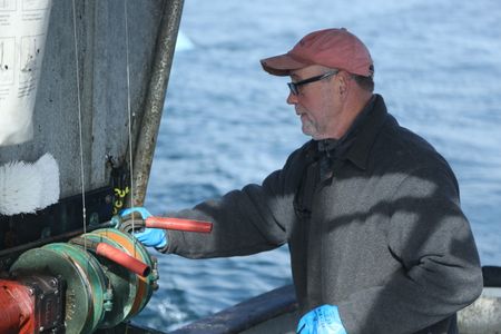 Sam Carlson fishes for salmon near the end of the summer troll season. (National Geographic/Wayne Moss)
