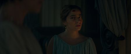 Amalthea, played by Buket Komur, speaks to the guests sheltering at Julia Felix's house, helping Julia convince them it is time to leave. (National Geographic)
