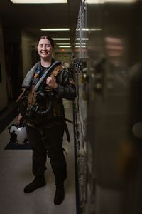 Student LT Carissa Meinster posing in the hallway on base. (Credit: National Geographic/Freddie Claire)