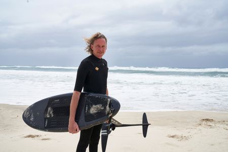 Christian Bungate with his foil board at Cabarita Beach. (National Geographic/Justine Kerrigan)