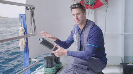 Charlie Huveneers, expert, holding a shark tag device whilst explaining the amount of great white sharks they have tagged in the past. (National Geographic)