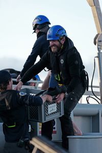Josh Palmer, Steve Hudson and Aldo Kane load gear onto the Metal Shark from the OceanXplorer. (National Geographic/Mario Tadinac)