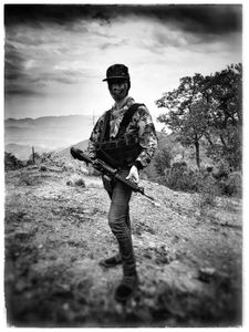 A masked narco stands guard with a rifle in Sinaloa mountains. (Nick Quested)