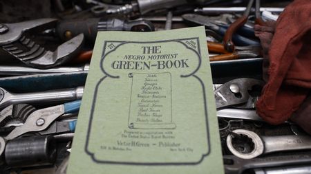 BLACK TRAVEL ACROSS AMERICA - A 1940 edition of the Negro Motorist Green-Book was a vital resource for African-American travelers  looking for safe lodging and services before and after segregation. (National Geographic for Disney)