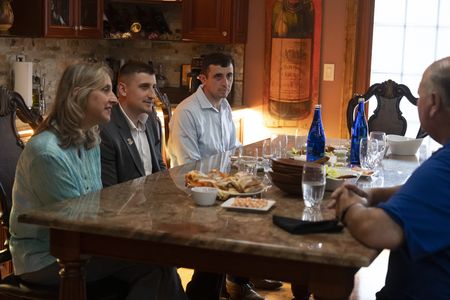 Carol D'Allara and her sons Nicholas and John, sit with Bill Spade and his family during their reunion. (National Geographic/Virginia Sherwood)