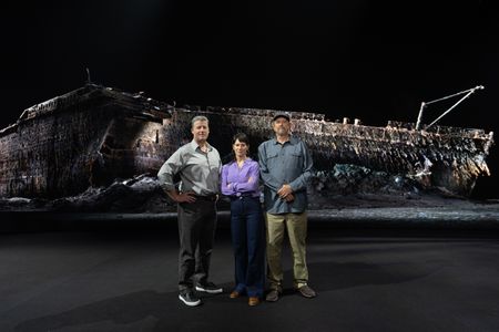 Chris Hearn, Jennifer Hooper, and Parks Stephenson stand in front of the Titanic digital twin in the virtual studio. (National Geographic/Gary Moyes)