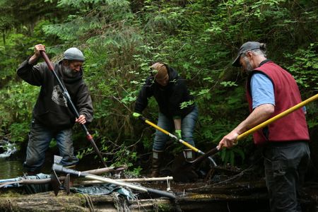 Dave Palmer, Veronica Arrants and Jiggy Nichols rebuild a dam in their community. (National Geographic/Wayne Moss)